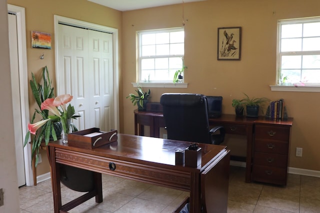 office area with light tile patterned flooring and plenty of natural light