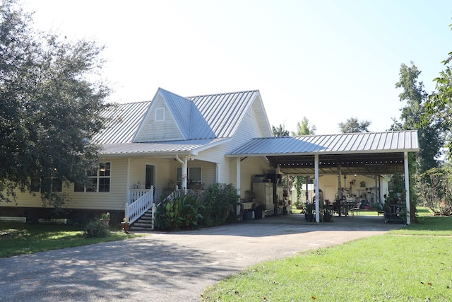 view of front of house featuring covered porch, a front lawn, and a carport