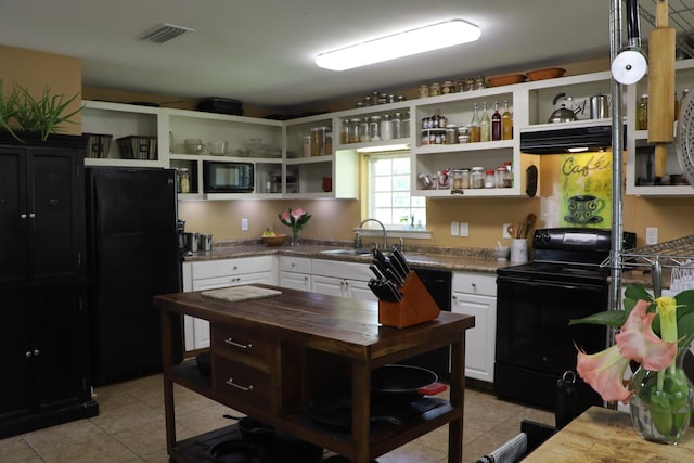 kitchen featuring black appliances, white cabinetry, sink, and light tile patterned flooring