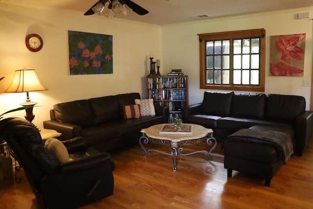 living room with ceiling fan, hardwood / wood-style flooring, and ornamental molding