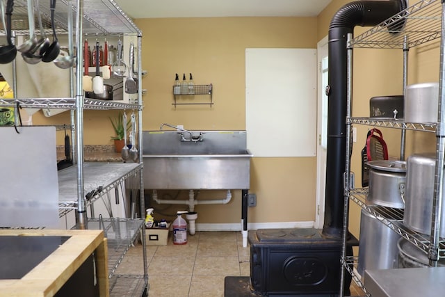 miscellaneous room with tile patterned flooring and sink