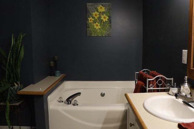 bathroom featuring vanity and a bath