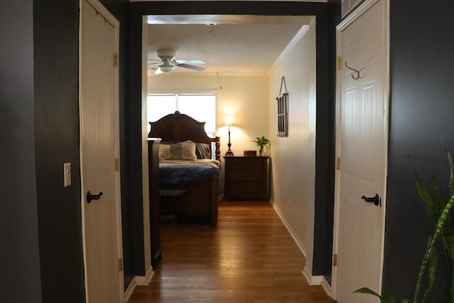 bedroom with hardwood / wood-style flooring and crown molding