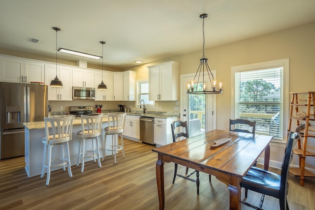 dining area with sink and hardwood / wood-style floors