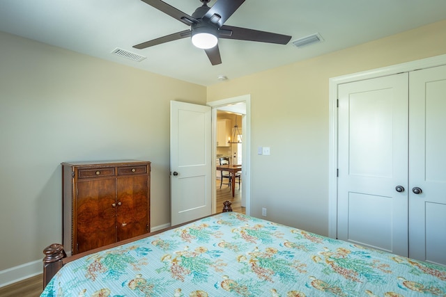 bedroom featuring hardwood / wood-style floors, a closet, and ceiling fan