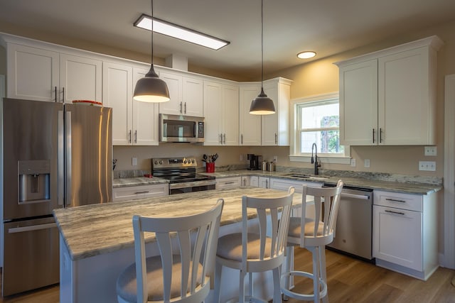 kitchen featuring stainless steel appliances, sink, and white cabinets