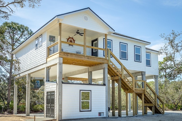 back of property featuring a balcony and ceiling fan