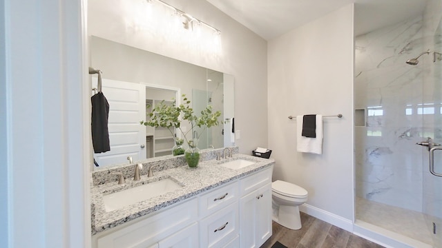 1009 Syrup Mill Creek Ln, Cairo, GA 39828 - bathroom featuring a marble finish shower, wood finished floors, toilet, and double vanity
