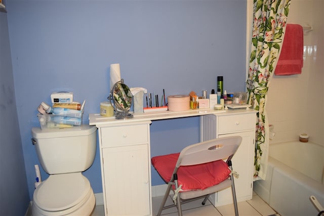 bathroom featuring tile patterned flooring, shower / bath combo, and toilet