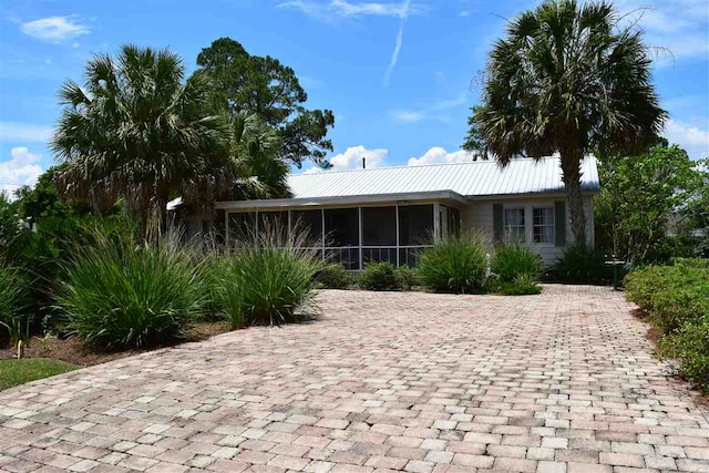 view of front of home featuring a sunroom