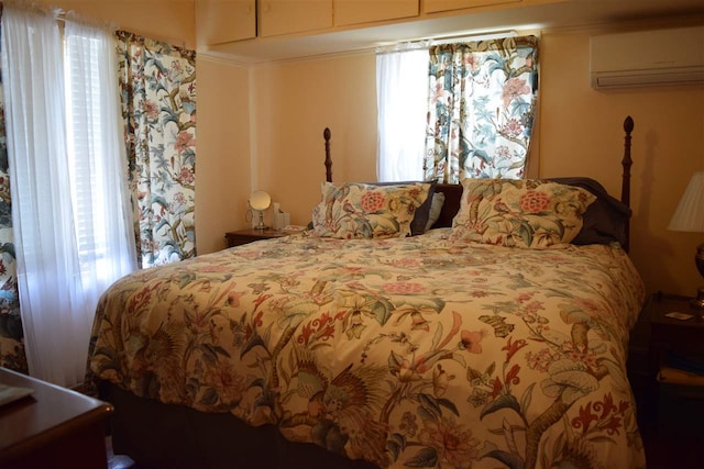 bedroom with a wall unit AC and multiple windows