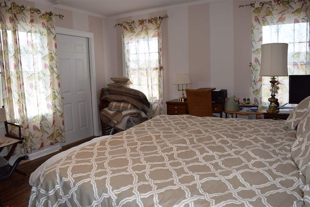 bedroom featuring dark hardwood / wood-style floors and crown molding