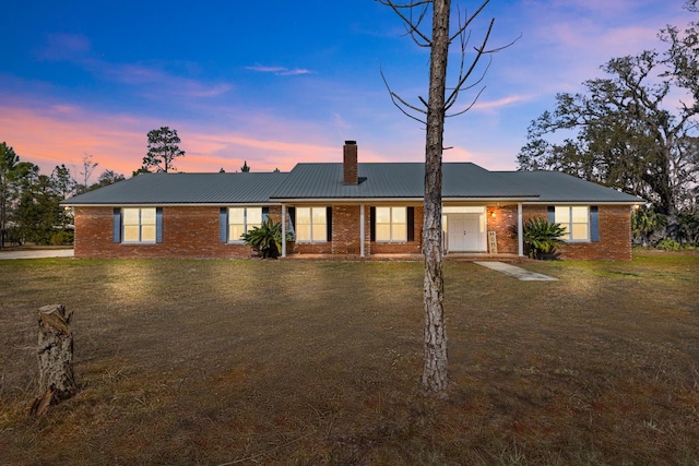 ranch-style home with a yard