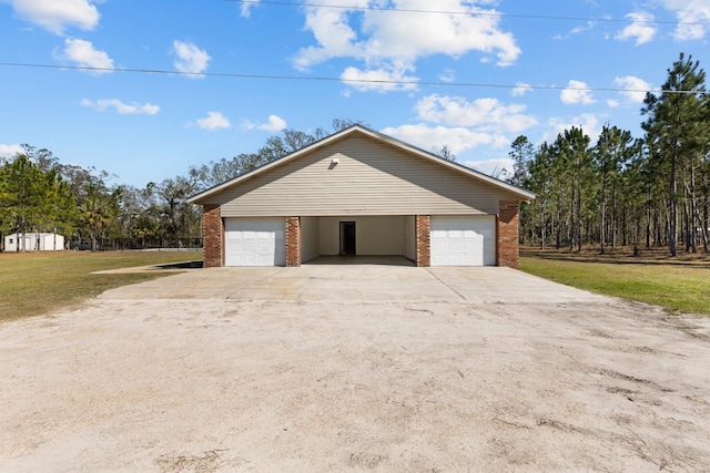 garage featuring a lawn