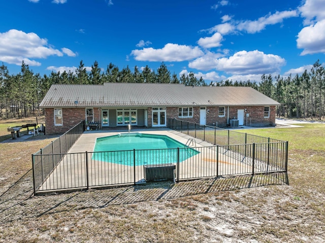 view of pool with central AC and a patio