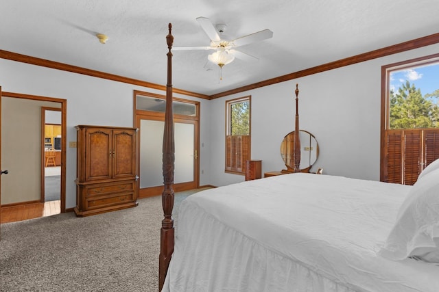 carpeted bedroom featuring ornamental molding, a textured ceiling, and ceiling fan