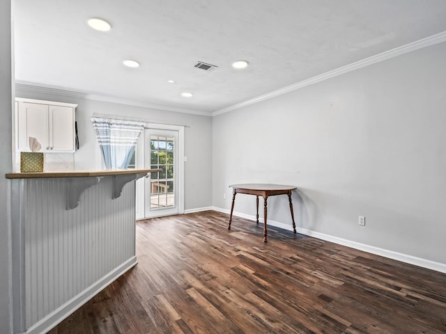 interior space featuring dark hardwood / wood-style floors and crown molding