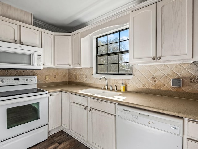 kitchen with white appliances, crown molding, dark wood-type flooring, and sink