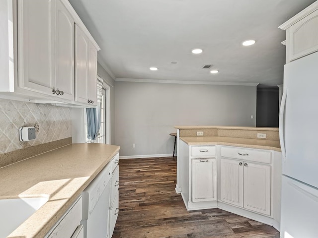 kitchen featuring crown molding, white cabinets, dark wood-type flooring, and white appliances