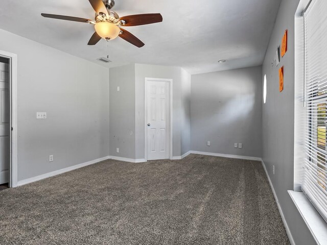 carpeted empty room featuring ceiling fan