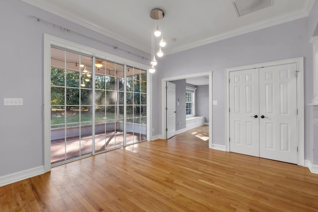 interior space with hardwood / wood-style flooring and crown molding