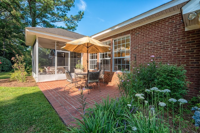 view of patio / terrace featuring ceiling fan and a sunroom