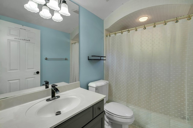 bathroom featuring toilet, curtained shower, and vanity