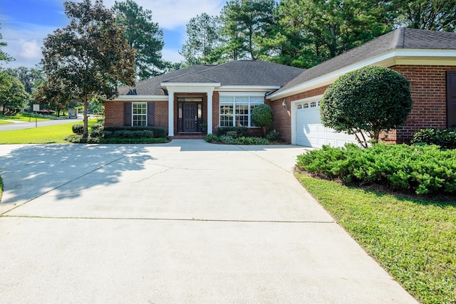 ranch-style home with a front yard and a garage