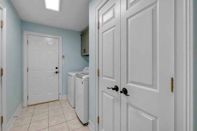 laundry area with independent washer and dryer, cabinets, and light tile patterned floors