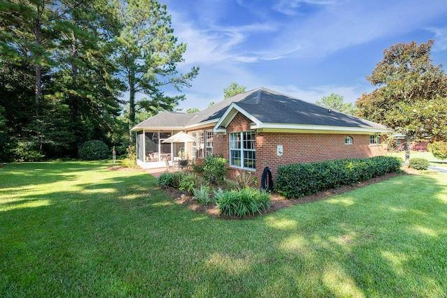 view of property exterior featuring a yard, a sunroom, and a patio area