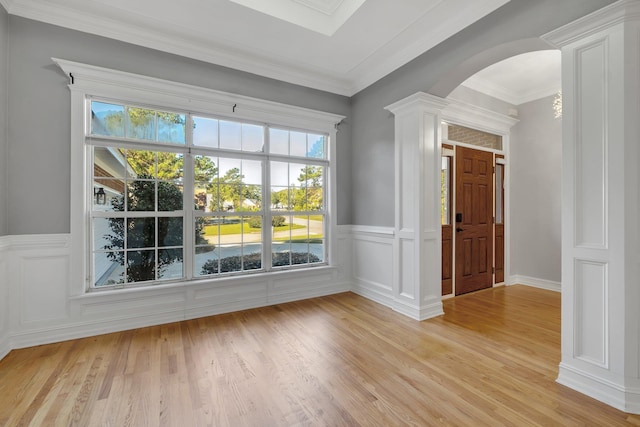 spare room featuring light hardwood / wood-style floors and crown molding