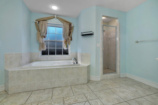 bathroom with tile patterned flooring and independent shower and bath