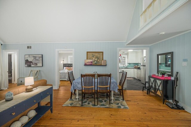 3206 Old Bainbridge Rd, Tallahassee, FL 32303 - dining area featuring visible vents, a high ceiling, wood finished floors, and ornamental molding