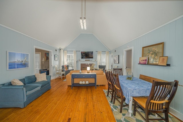 3206 Old Bainbridge Rd, Tallahassee, FL 32303 - dining area featuring a fireplace, vaulted ceiling, crown molding, and wood finished floors