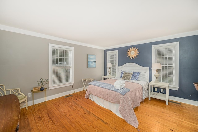 3206 Old Bainbridge Rd, Tallahassee, FL 32303 - bedroom with crown molding, wood finished floors, visible vents, and baseboards