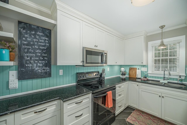3206 Old Bainbridge Rd, Tallahassee, FL 32303 - kitchen with stainless steel microwave, crown molding, black range with electric cooktop, white cabinetry, and a sink