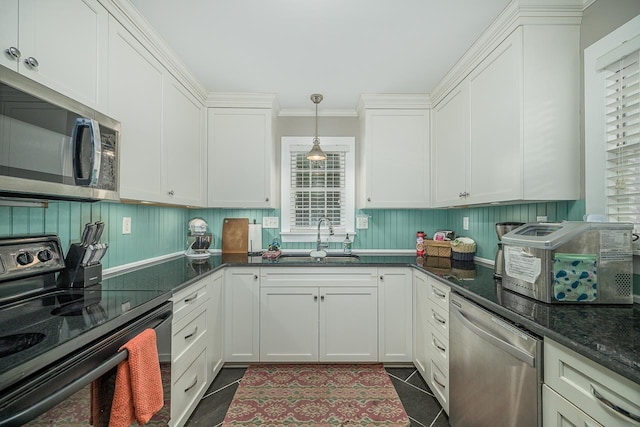 3206 Old Bainbridge Rd, Tallahassee, FL 32303 - kitchen with a sink, a toaster, appliances with stainless steel finishes, white cabinetry, and dark tile patterned flooring