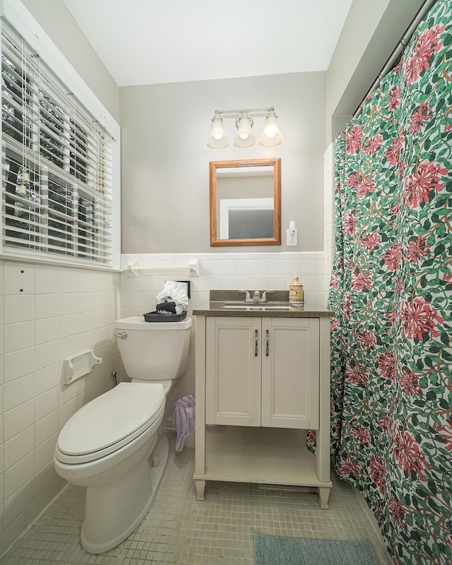 3206 Old Bainbridge Rd, Tallahassee, FL 32303 - full bathroom with toilet, tile walls, wainscoting, and tile patterned flooring