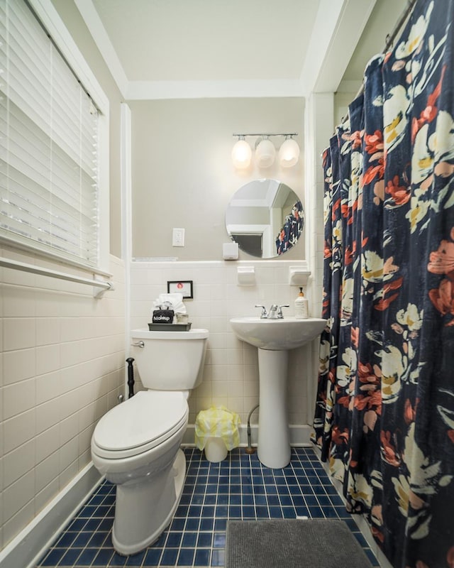 3206 Old Bainbridge Rd, Tallahassee, FL 32303 - full bath featuring a wainscoted wall, toilet, tile patterned floors, tile walls, and a sink