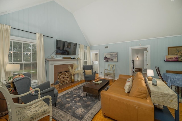 3206 Old Bainbridge Rd, Tallahassee, FL 32303 - living area featuring visible vents, a fireplace, wood finished floors, and vaulted ceiling