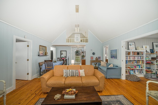 3206 Old Bainbridge Rd, Tallahassee, FL 32303 - living area featuring an inviting chandelier, wood finished floors, ornamental molding, and vaulted ceiling