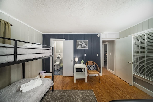 3206 Old Bainbridge Rd, Tallahassee, FL 32303 - bedroom with a textured ceiling, wood finished floors, and ornamental molding