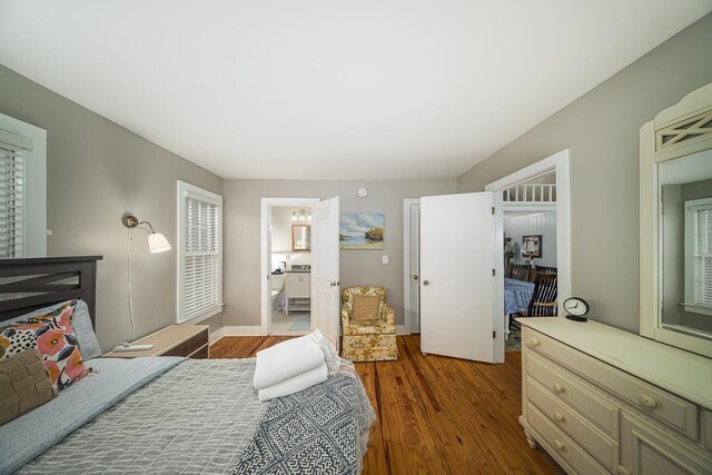 3206 Old Bainbridge Rd, Tallahassee, FL 32303 - bedroom with ensuite bath, wood finished floors, and baseboards