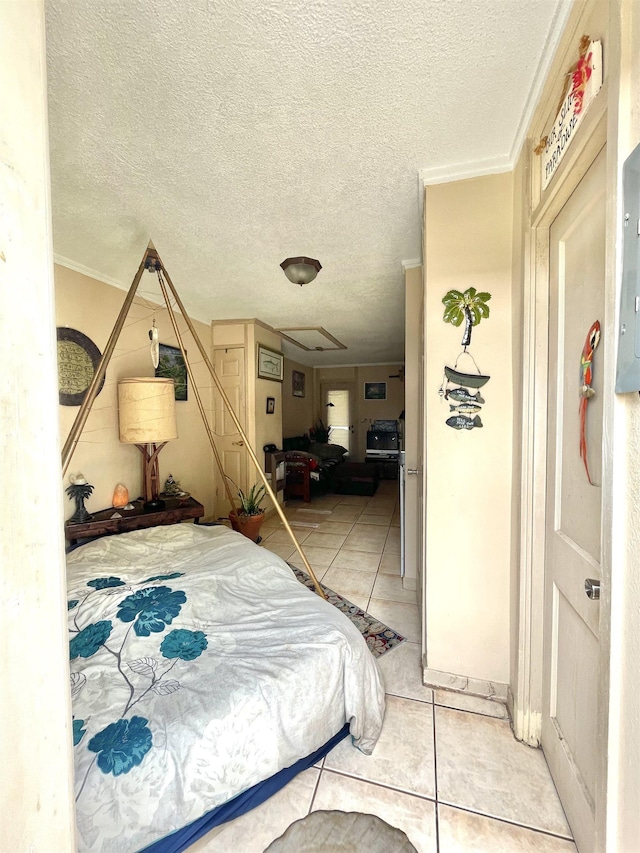 bedroom with tile patterned flooring, a textured ceiling, and ornamental molding