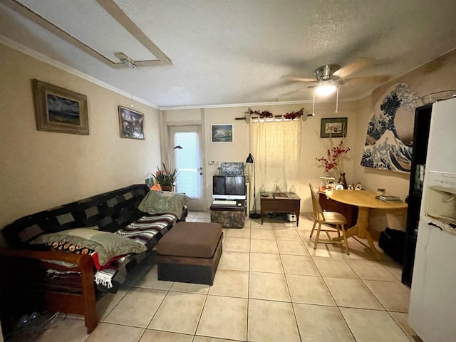 living room featuring a textured ceiling, ceiling fan, light tile patterned floors, and crown molding