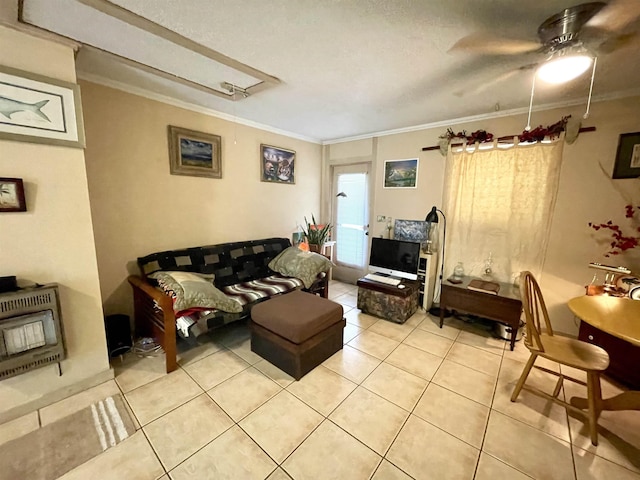 living room with heating unit, ceiling fan, tile patterned flooring, and ornamental molding