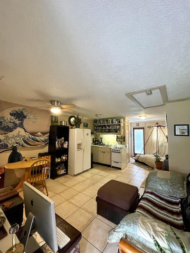 tiled living room with ceiling fan and a textured ceiling