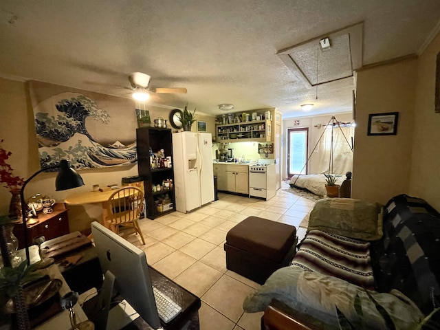 living room featuring ceiling fan, light tile patterned flooring, ornamental molding, and a textured ceiling