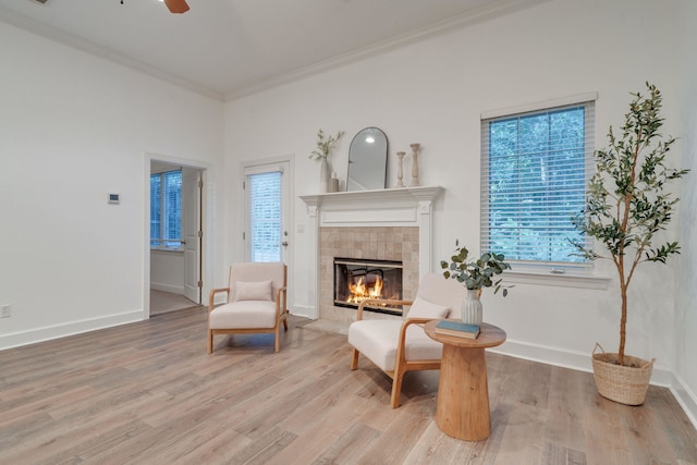 3283 Gramercy Pl, Tallahassee, FL 32308 - living area with a tile fireplace, plenty of natural light, wood finished floors, ornamental molding, and ceiling fan