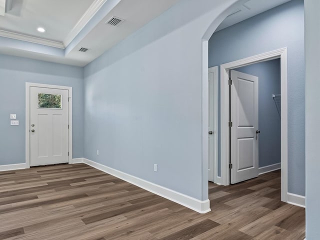 entryway with a raised ceiling and dark hardwood / wood-style floors